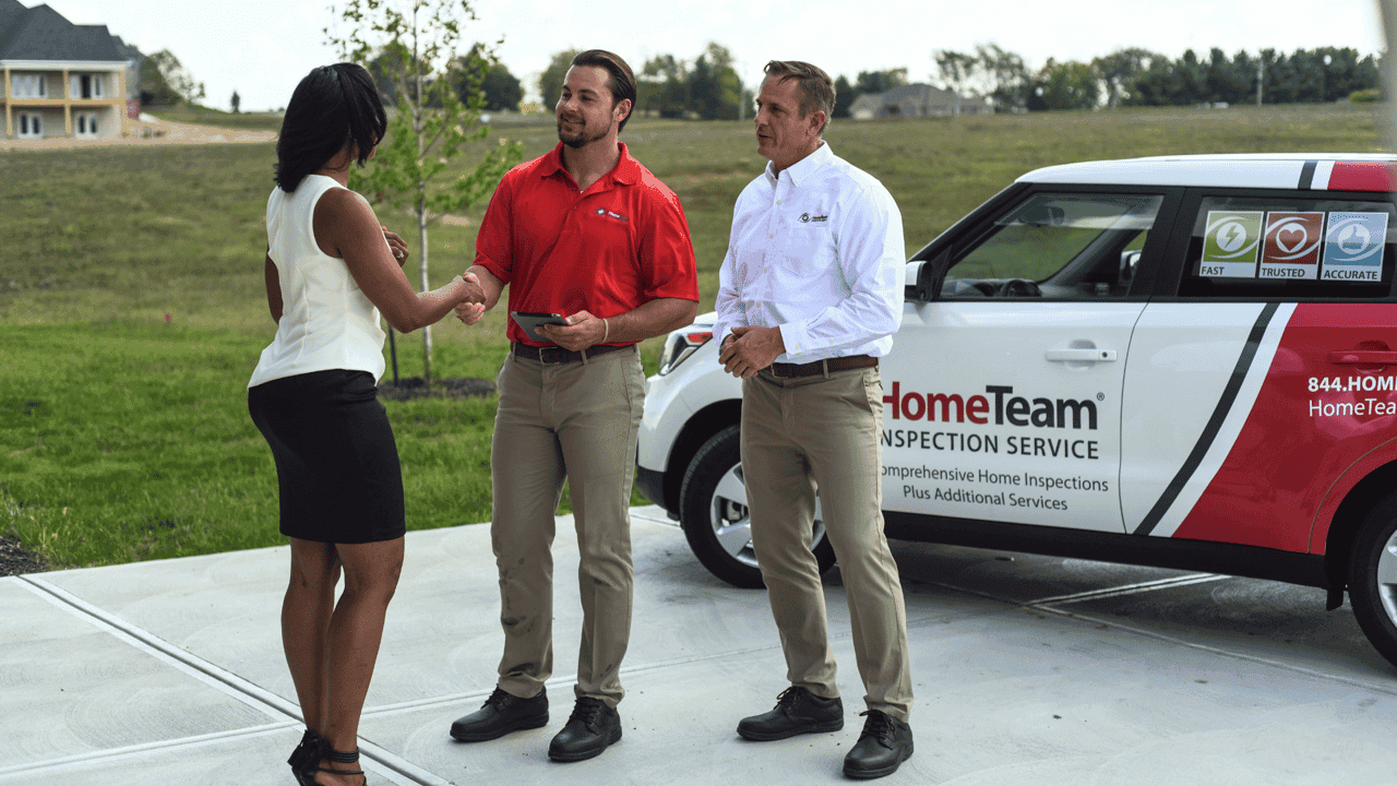How HomeTeam Inspection Service Evolved and Set New Standards Photo of HomeTeam Inspection Service team speaking with client