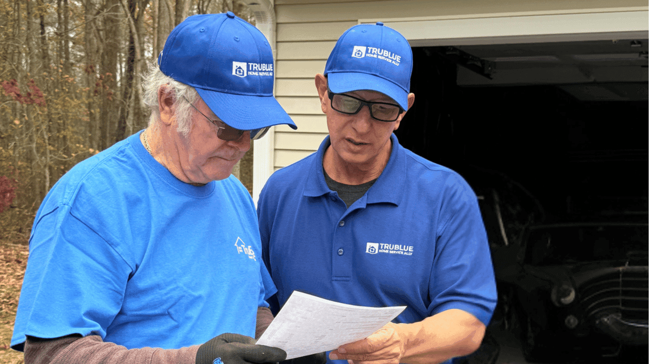 How TruBlue Home Service Ally Evolved and Set New Standards Photo of two TruBlue Home Service Ally team members looking at paper